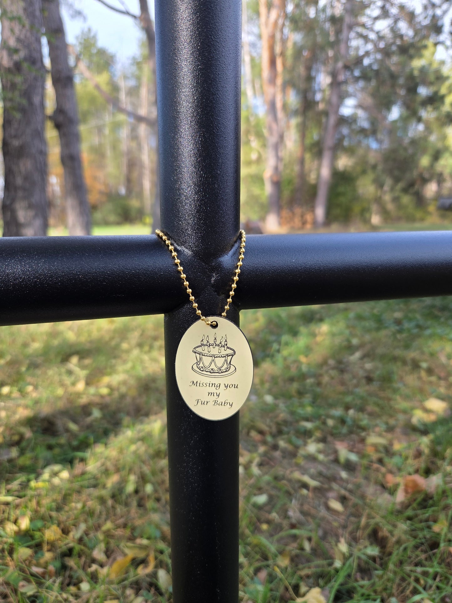 Outdoor memorial shown with EC Angle Charm to celebrate love ones Birthday. Black Ebony Urn Cross with Ivory Birthday Cake EC Angle Charm