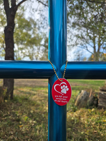 Blue Topaz showing EC Charm with gold chain, red finish, heart with paw.  Engraving personalized in Lucida Calligraphy font. To symbolize a special memory.