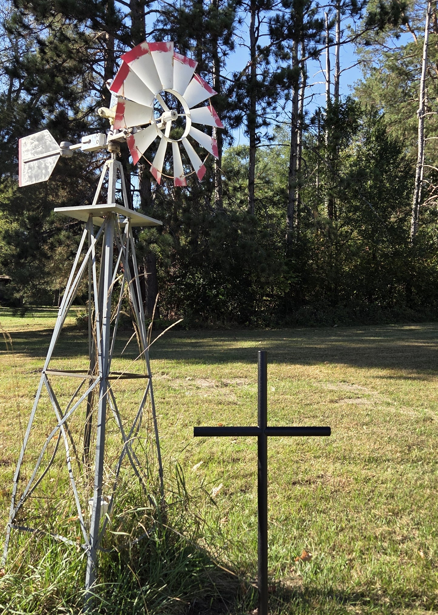 Everlasting Cross Urn memorial shown in Black Ebony finished in its forever resting place next to their Windmill.  Standing 41 inches tall by 21 inches wide.  