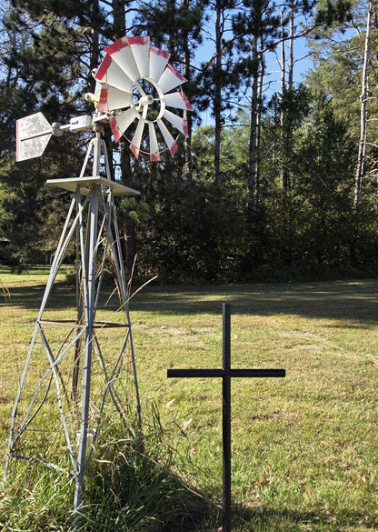 Everlasting Cross Urn memorial shown in Black Ebony finished in its forever resting place next to their Windmill.  Standing 41 inches tall by 21 inches wide.  