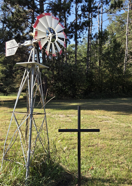 Everlasting Cross Urn memorial shown in Black Ebony finished in its forever resting place next to their Windmill.  Standing 41 inches tall by 21 inches wide.  
