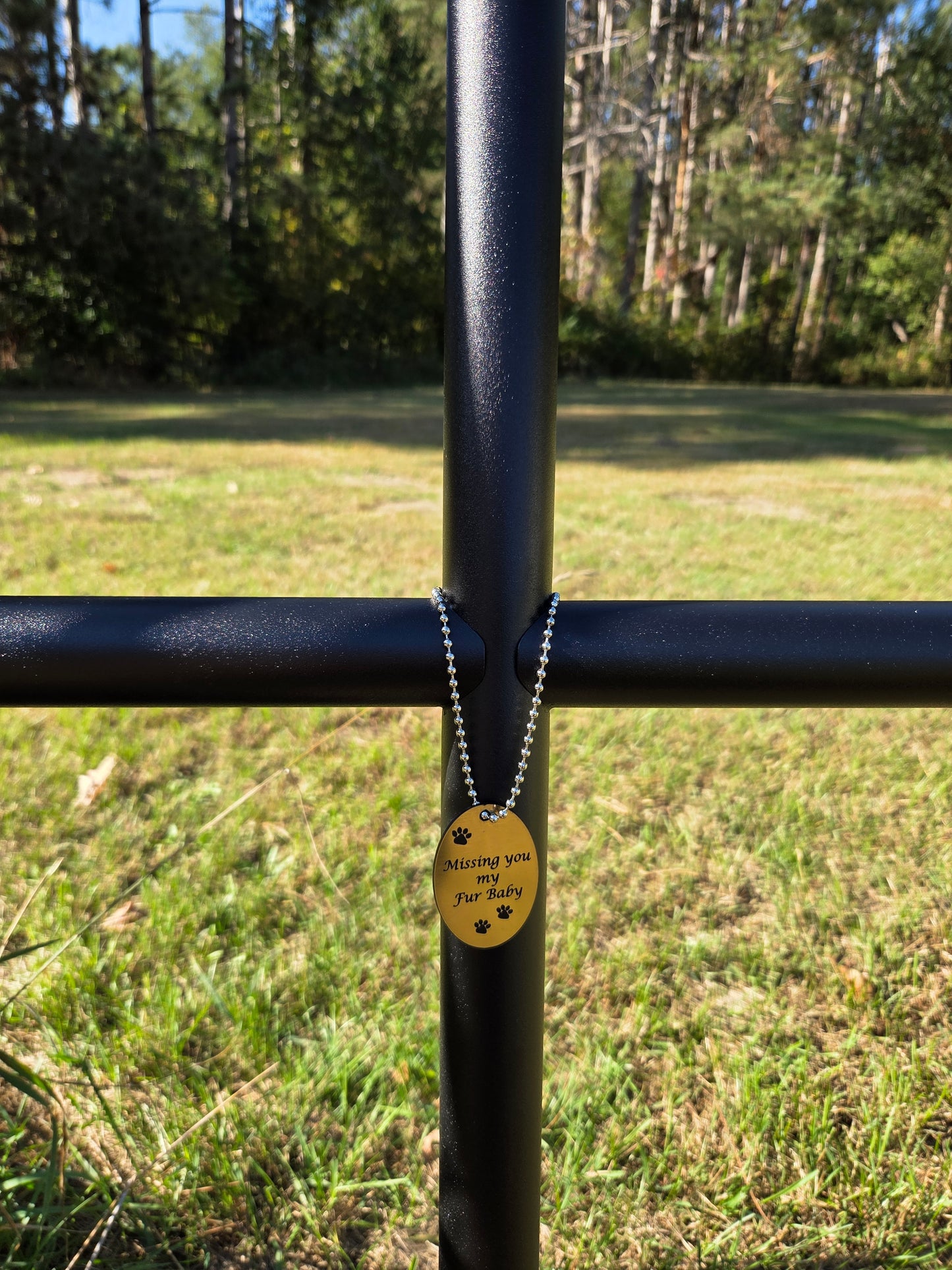 Memorial Outdoor Urn shown in a large size and celebrating the anniversary of their pet lost with a Gold EC Angle Charm and paw prints.  