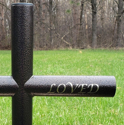 Copper Vein Everlasting Cross is a timeless Monument. Close view of the engraving - Loved - to show the Lucida Calligraphy font on the small size memorial. The Black plastic end caps is shown to add a finished touch and uniquely preserve in this timeless   tribute. 